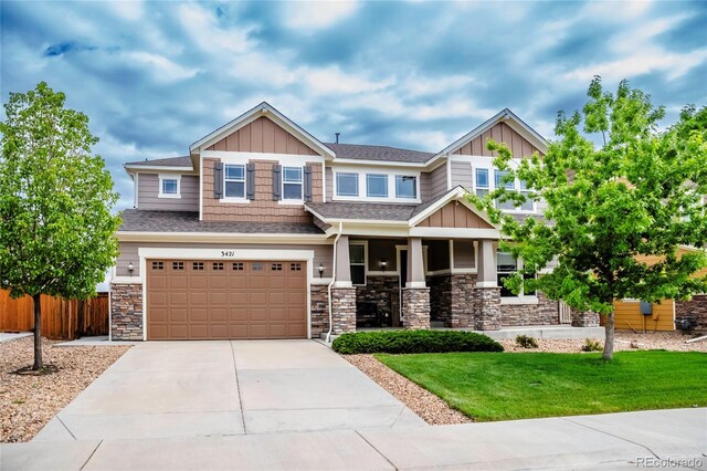 3421 E 143rd Dr, Thornton, CO 80602 - craftsman inspired home featuring board and batten siding, stone siding, a garage, concrete driveway, and a porch