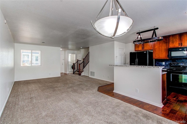 19043 E 58th Ave, Denver, CO 80249 - kitchen featuring black appliances, dark colored carpet, decorative backsplash, brown cabinetry, and a textured ceiling