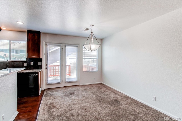 19043 E 58th Ave, Denver, CO 80249 - kitchen with dishwasher, hanging light fixtures, and a textured ceiling
