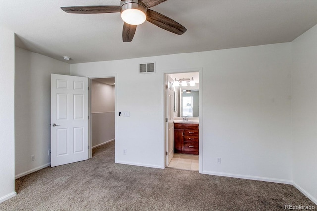 19043 E 58th Ave, Denver, CO 80249 - unfurnished bedroom with light colored carpet, a walk in closet, connected bathroom, and ceiling fan