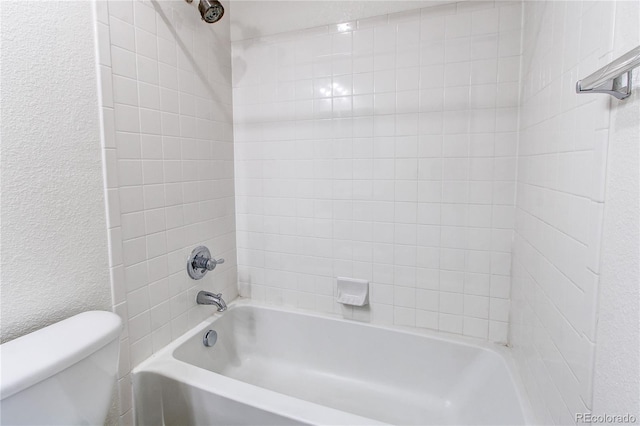 19043 E 58th Ave, Denver, CO 80249 - bathroom with a textured wall and washtub / shower combination