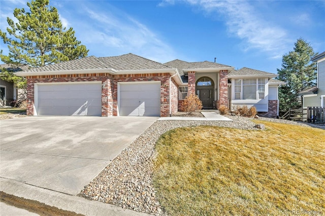 single story home with a garage, concrete driveway, brick siding, and a front lawn