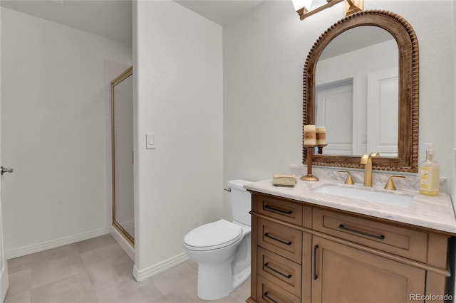 bathroom with a stall shower, vanity, toilet, and baseboards