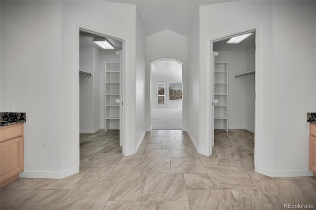 spacious closet with arched walkways