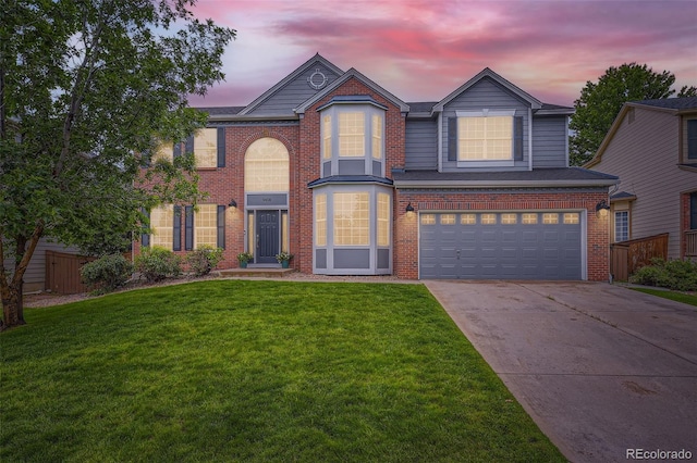 9458 S Hackberry Ln, Highlands Ranch, CO 80129 - traditional-style house featuring driveway, a garage, and brick siding