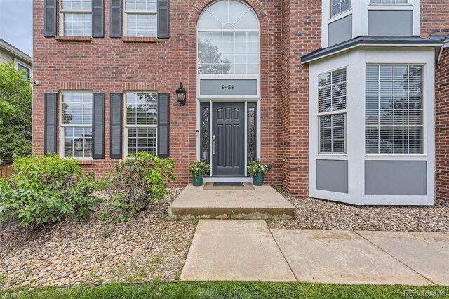 9458 S Hackberry Ln, Highlands Ranch, CO 80129 - doorway to property with brick siding