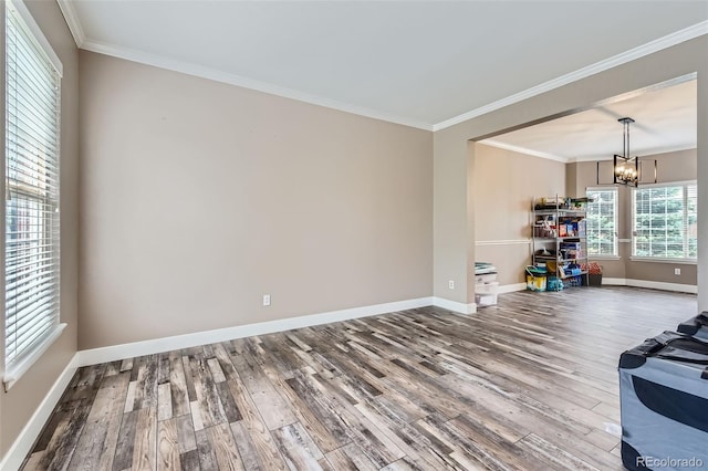 9458 S Hackberry Ln, Highlands Ranch, CO 80129 - spare room featuring wood finished floors, a chandelier, baseboards, and ornamental molding