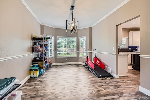 9458 S Hackberry Ln, Highlands Ranch, CO 80129 - workout area featuring ornamental molding, wood finished floors, a chandelier, and baseboards