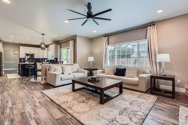 9458 S Hackberry Ln, Highlands Ranch, CO 80129 - living area featuring plenty of natural light, ceiling fan, hardwood / wood-style flooring, recessed lighting, and baseboards