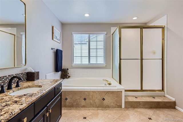 9458 S Hackberry Ln, Highlands Ranch, CO 80129 - bathroom with vanity, a stall shower, a garden tub, and recessed lighting