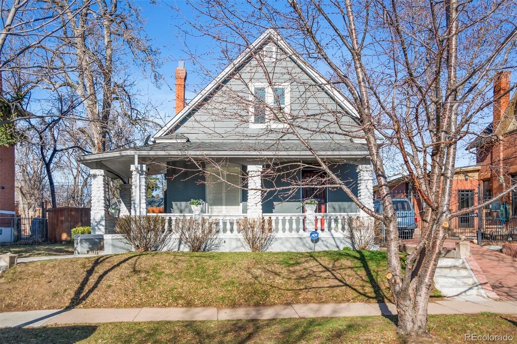 3931 King St, Denver, CO 80211 - view of front of property with a chimney, fence, a front lawn, and covered porch