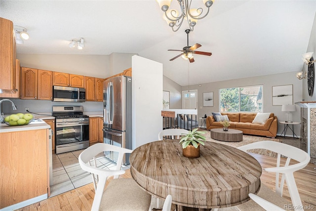 9712 Adams St, Thornton, CO 80229 - dining room featuring vaulted ceiling, a ceiling fan, and light wood-style floors