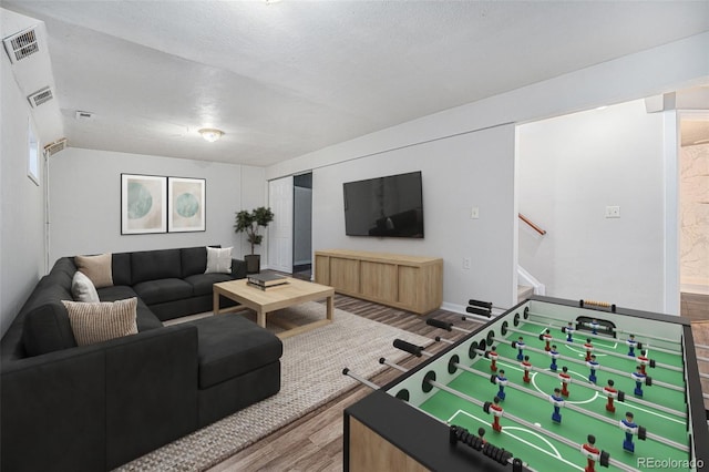 9712 Adams St, Thornton, CO 80229 - playroom with wood finished floors and a textured ceiling