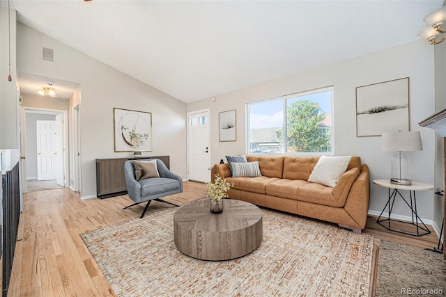 9712 Adams St, Thornton, CO 80229 - living area featuring light wood finished floors, lofted ceiling, and baseboards