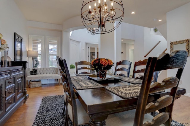 dining space featuring an inviting chandelier and light hardwood / wood-style flooring