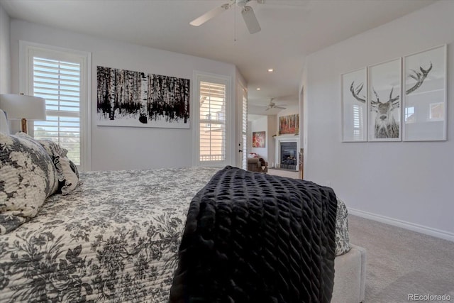 bedroom with carpet flooring, multiple windows, and ceiling fan