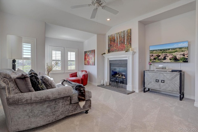 carpeted living room featuring ceiling fan and vaulted ceiling