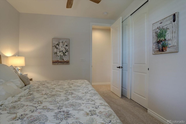 carpeted bedroom featuring ceiling fan and a closet