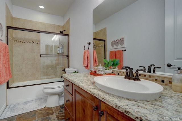 full bathroom with toilet, vanity, and combined bath / shower with glass door