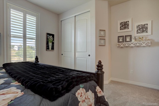 bedroom with light colored carpet and a closet