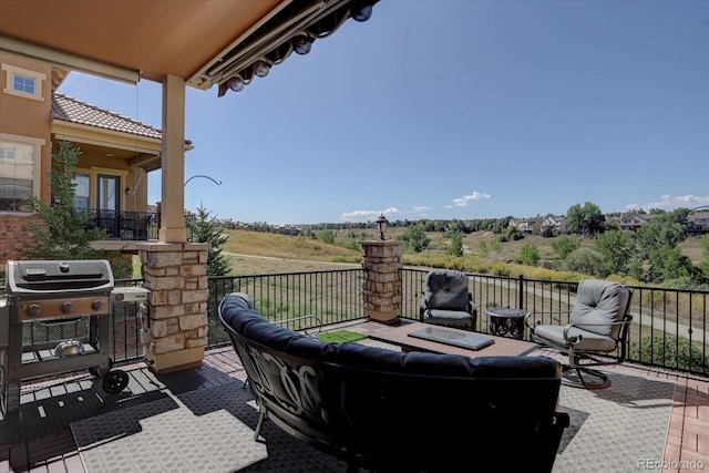 view of patio featuring a balcony and a grill