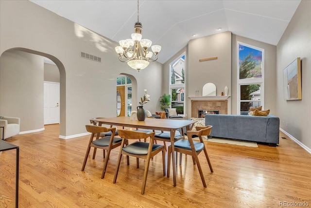 dining area featuring a wealth of natural light, a chandelier, and light wood-type flooring