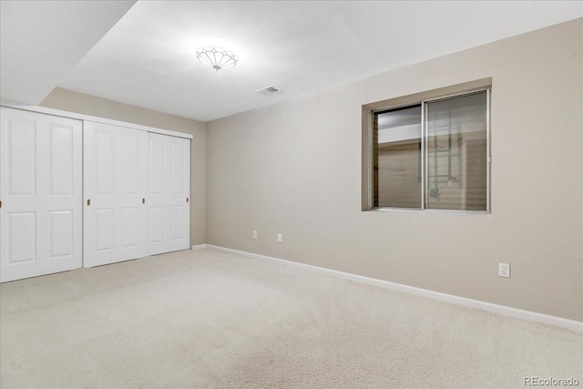 unfurnished bedroom with carpet floors and a closet