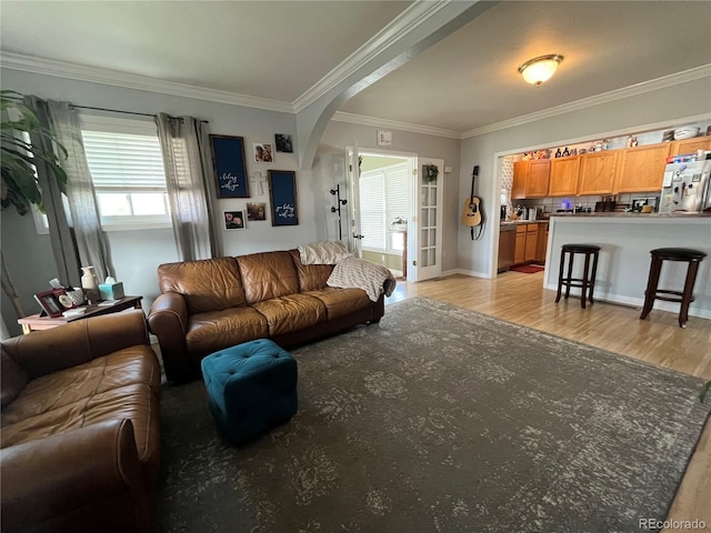 790 4th St, Limon, CO 80828 - living area with arched walkways, crown molding, light wood-type flooring, and baseboards