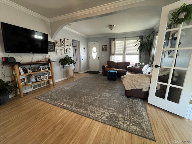 790 4th St, Limon, CO 80828 - living area with arched walkways, crown molding, wood finished floors, and baseboards