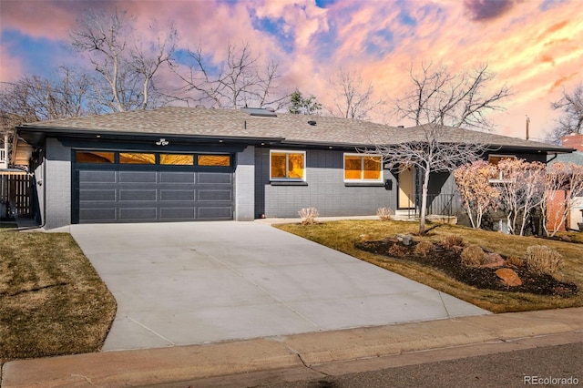 view of front facade with brick siding, driveway, an attached garage, and roof with shingles