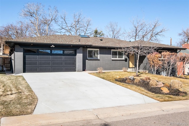 single story home featuring concrete driveway, brick siding, an attached garage, and roof with shingles