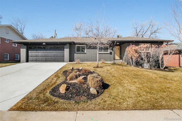 ranch-style house featuring a garage, concrete driveway, and a front yard