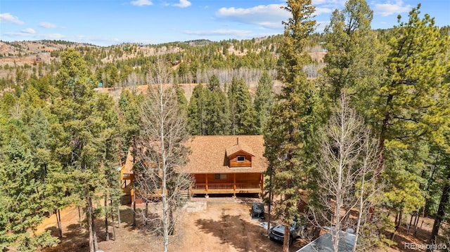 birds eye view of property with a wooded view