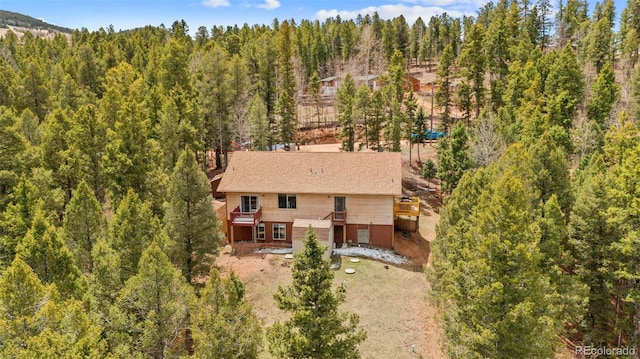 aerial view featuring a wooded view
