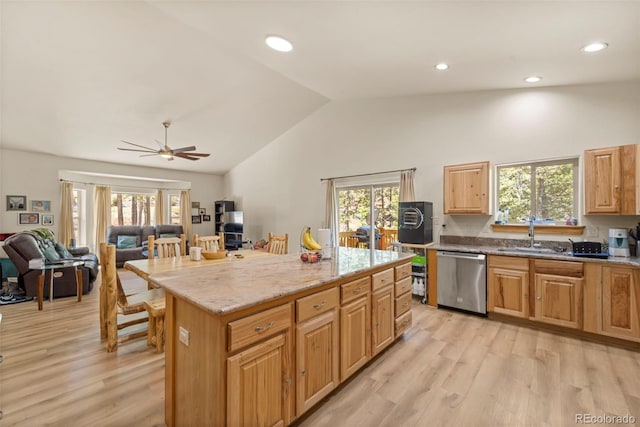 kitchen featuring light wood-style flooring, a sink, lofted ceiling, and dishwasher