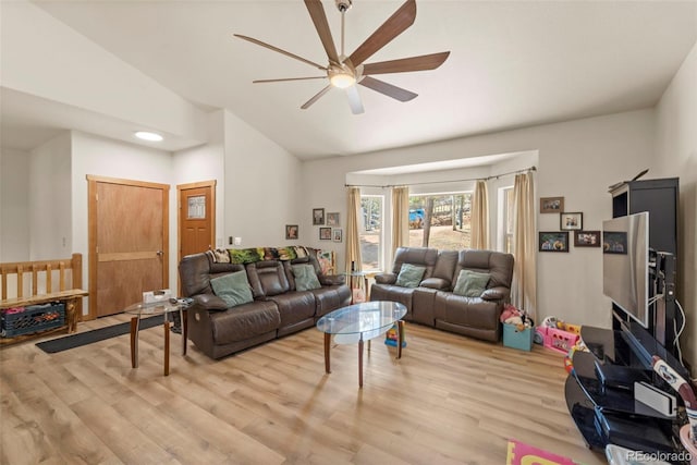 living area featuring ceiling fan, vaulted ceiling, and light wood-style floors