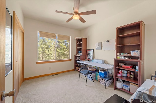 home office with carpet floors, baseboards, ceiling fan, and visible vents
