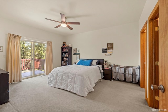 carpeted bedroom featuring access to outside and a ceiling fan