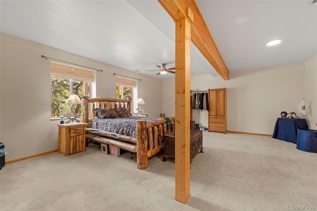 bedroom featuring baseboards, light colored carpet, and ceiling fan