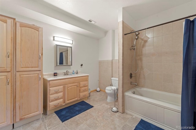 full bathroom with vanity, toilet, visible vents, and shower / bath combo with shower curtain