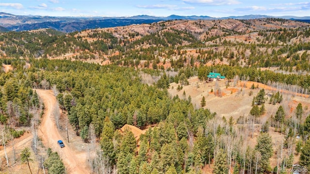 birds eye view of property with a view of trees and a mountain view