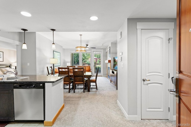 kitchen featuring stainless steel dishwasher, light colored carpet, ceiling fan, sink, and pendant lighting