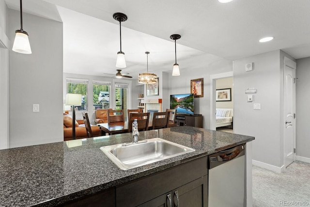 kitchen with stainless steel dishwasher, decorative light fixtures, ceiling fan, and light carpet