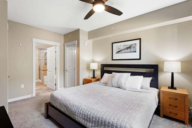 bedroom with ensuite bath, ceiling fan, and light carpet