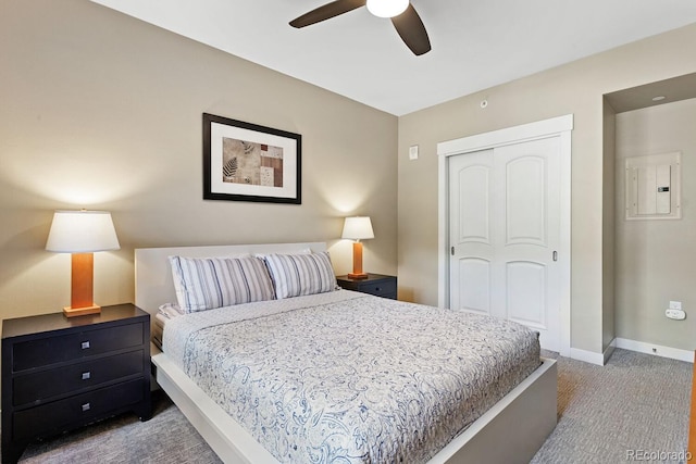 bedroom featuring electric panel, ceiling fan, a closet, and carpet floors