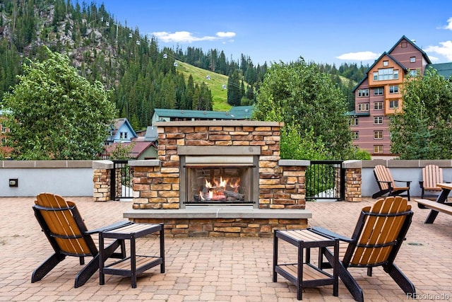 view of patio / terrace featuring an outdoor stone fireplace