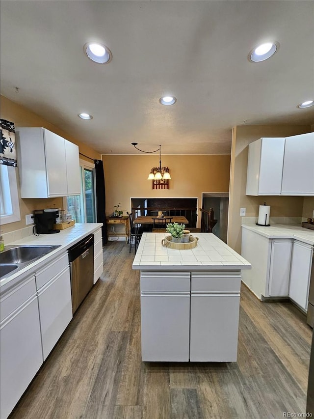 2034 S Truckee St, Aurora, CO 80013 - kitchen featuring stainless steel dishwasher, a center island, white cabinets, wood finished floors, and recessed lighting