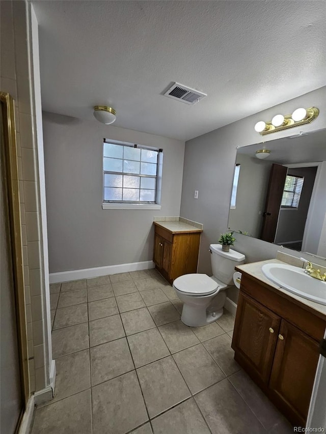 2034 S Truckee St, Aurora, CO 80013 - full bathroom with vanity, healthy amount of natural light, tile patterned flooring, and a textured ceiling