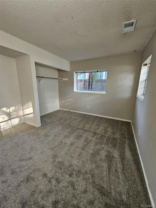 2034 S Truckee St, Aurora, CO 80013 - unfurnished bedroom with carpet floors, a textured ceiling, and a closet