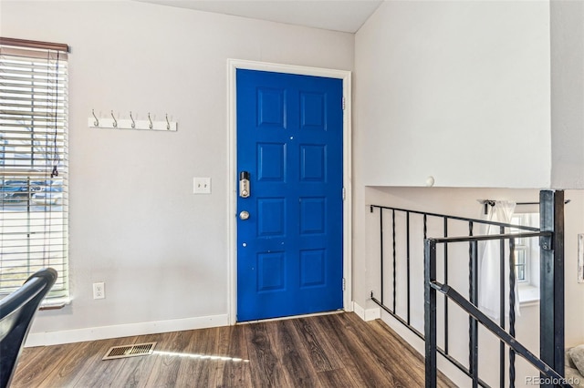 entryway featuring visible vents, a healthy amount of sunlight, baseboards, and wood finished floors